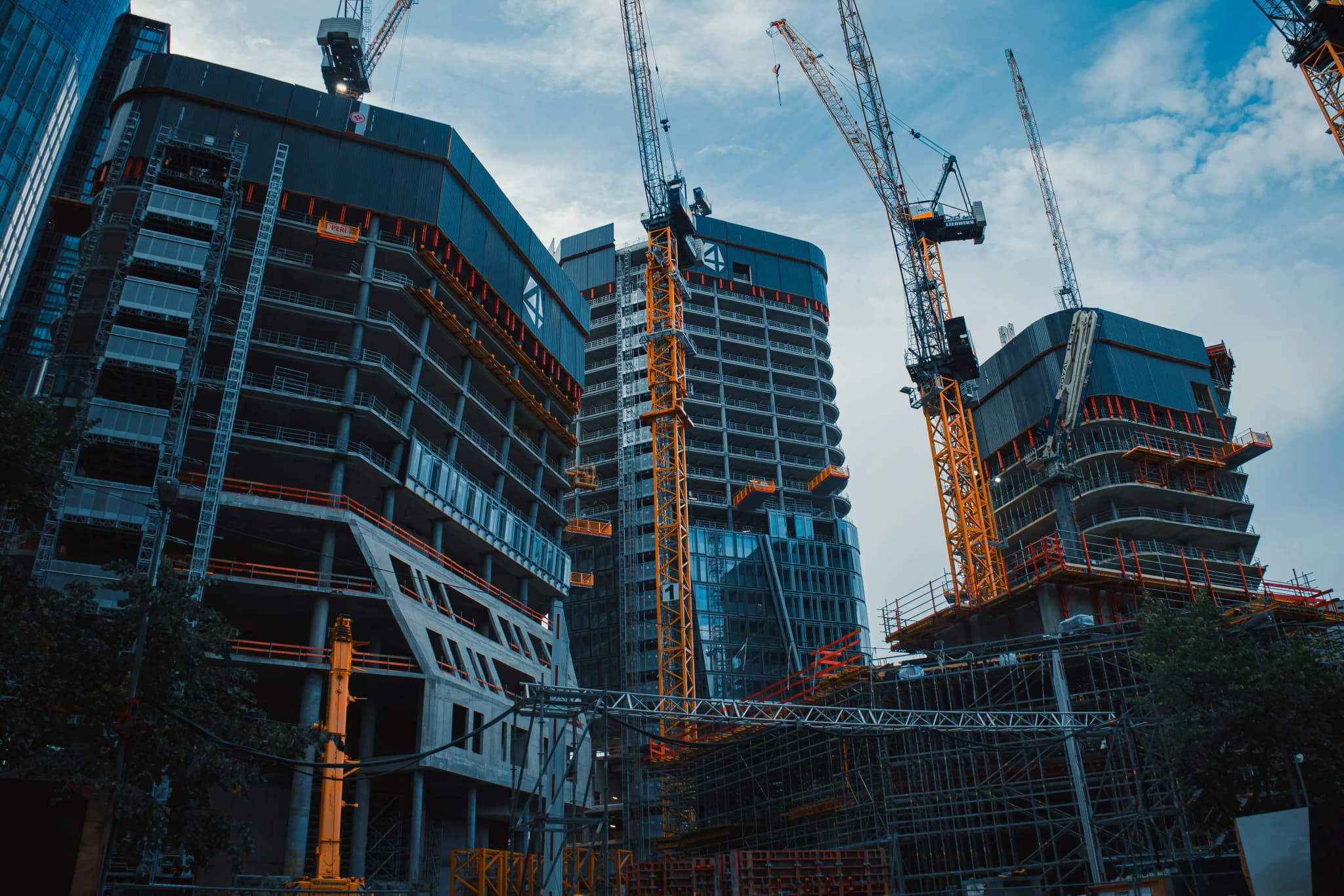 Commercial towers going up behind tower cranes on a city site